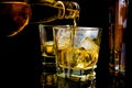 Barman pouring whiskey in front of whiskey glass and bottles Royalty Free Stock Photo