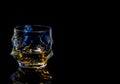 Barman pouring whiskey in front of whiskey glass and bottles on black table with reflection Royalty Free Stock Photo