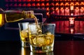 Barman pouring whiskey in a lounge bar Royalty Free Stock Photo