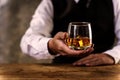 Barman pouring wiskey whiskey glass and giving Royalty Free Stock Photo
