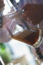 Barman pours a dark foamy beer into a large mug during the Oktoberfest party. Royalty Free Stock Photo