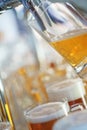 Barman pours a light foamy beer into a large mug during the Oktoberfest party. Royalty Free Stock Photo