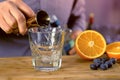 Barman pours the tequila from jigger to rocks glass preparing alcohol cocktail. Hands close-up. Royalty Free Stock Photo