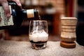 Barman preparing and pouring alcoholic drink into cocktail glass Royalty Free Stock Photo