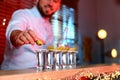 Barman putting lime on shot glass of Mexican Tequila at bar counter Royalty Free Stock Photo