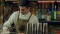 Barman rub metal shakes with napkin at work place