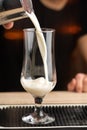 Barman& x27;s hands in bar making alcohol shot cocktail. Professional bartender at work in bar pouring coconut syrup into Royalty Free Stock Photo