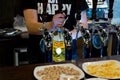 Barman serving draught beer in a pub