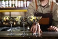 Barman serving glasses of lemon drop martini on counter, closeup.