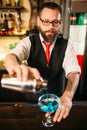 Barman with shaker making alcohol cocktail