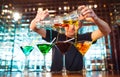 Barman show. Bartender pours alcoholic cocktails at the bar. Royalty Free Stock Photo