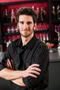 Barman wear black standing at cocktail bar