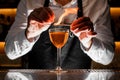 Barman making a fresh alcoholic drink with a smoky note