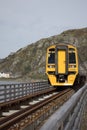 BARMOUTH, GWYNEDD UK - APRIL 09 : Train travelling over the viaduct in Barmouth, Gwynedd on April 09, 2023