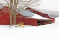 Barn and cultivator in snow, winter