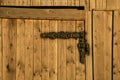 Barn door. Details of a door made of wood with black metal details at a cottage Royalty Free Stock Photo