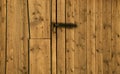 Barn door. Details of a door made of wood with black metal details at a cottage Royalty Free Stock Photo