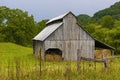 Barn full of rolled gray hay sits on hillside pasture in rural Virginia Royalty Free Stock Photo