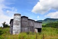 Barn Has Roofless Silo and Weathered Exterior