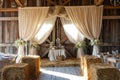Barn With Hay Bales, Tables, and Chairs, A rustic barn setting with hay bales and white linen drapes for a countryside wedding, AI Royalty Free Stock Photo