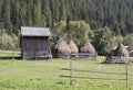 Rural barn and haystacks