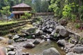 barn house besides dried river which is many stones