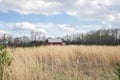 Barn House in a field of high wheat grass. Royalty Free Stock Photo