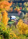 Barn in the middle of autumn trees Royalty Free Stock Photo