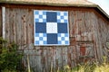 Barn quilt on old weathered building.