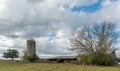 Barn and silo in a field with trees in rural North Carolina Royalty Free Stock Photo