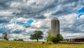 Barn and silo in a field with trees in rural North Carolina Royalty Free Stock Photo