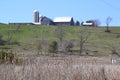 Barn and silos on lush green hill along hiking trail at Copeland Forest Royalty Free Stock Photo