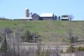 Barn and silos on lush green hill along hiking trail at Copeland Forest Royalty Free Stock Photo