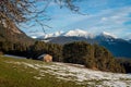 Barn on a sunny alpine winter meadow with melting snow, Wildermieming, Tirol, Austria