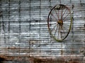 Barn Wall Holds Wire Wagon Wheel