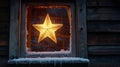 barn window with frost crystals and a glowing Christmas star shining Royalty Free Stock Photo