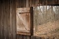 Barn window opened to a early spring woods