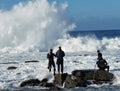 Barnacle fishermen work in Galicia in an area with lots of waves and underground sea