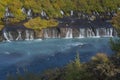 Barnafoss waterfall decorated with autumn trees