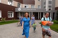 Young parents with a newborn baby come out of the discharge hall of the maternity hospital