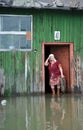 An unknown elderly woman in her home during a flood. The Ob river, which came out of the banks, flooded the outskirts of the city.