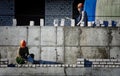 A bricklayer worker erects a wall on the construction of a multi-storey building Royalty Free Stock Photo