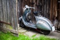 Barnfind old, rusty, used italian motorbike scooter on wooden wa Royalty Free Stock Photo