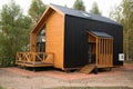 Barnhouse style house. House in the bosom of nature. Greenery and trees