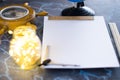 Barometer on a background of a white sheet of paper with lights in a glass jar. Royalty Free Stock Photo