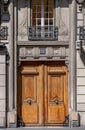 Beautiful antique double door entrance of old building in Paris France. Vintage wooden doorway and whimsical stucco fretwork wall Royalty Free Stock Photo