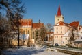 Baroque bell tower called Blatenska vez, Medieval Gothic Church of the Assumption of the Virgin Mary, snow in winter sunny day,