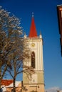 Baroque bell tower called Blatenska vez in winter, Narrow picturesque street, renaissance historical buildings with snow, Blatna