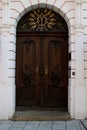 Baroque brown door with golden and black metal elements in a pink facade Royalty Free Stock Photo