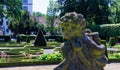 Baroque garden with a deliberately blurred stone figure in the foreground